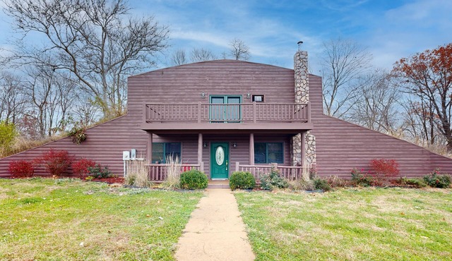 Cozy Hobbit House inspired home with large balcony and front porch